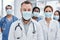 Doctors hold a key role in enhancing clinical services. Portrait of a group of medical practitioners wearing face masks