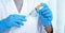 Doctors hold the syringe, vaccine, cure virus, bacteria and in there the yellow chemical liquid for research and analysis in a