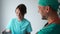 Doctors, a man and a woman are talking and laughing in the hallway of the clinic. Medical staff in their free time