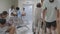 Doctors and nurse and patient walking at corridor in hospital.