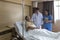 Doctors and physical therapists are caring for elderly sick people. Doctor and nurse taking care of elderly patient on the bed at