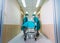 doctors push patient bed into operating room