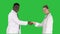 Doctors shaking hands and posing to camera on a Green Screen, Chroma Key.