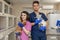 Doctors veterinarians girl and a guy in uniform are holding a cat and a dog on the background of the hospital in a veterinary