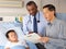 Doctors Visiting Child Patient On Ward