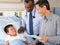 Doctors Visiting Child Patient On Ward