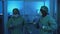 Doctors wearing personal protective equipment having fun dancing in laboratory - Health care and medical workers concept