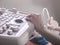 doctorâ€™s hands, using an ultrasound scanner, examine the patientâ€™s organs