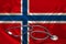 Doctorâ€™s tool, medical stethoscope, lies on the silk national flag of the state of Norway, concept of tourism, insurance, health