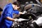 Document, man and technician check engine of car, repair and maintenance. Checklist, mechanic and serious person on