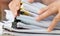 Document Report and business busy Concept: Asian Businessman hands working in many documents Stacks of folders in office for