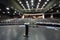 Document stand on stage and rows of chairs with handrails in large hall for business meetings