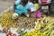 Documentary editorial image. Vendor selling fresh flowers, vegetables, fruits, umbrella for devotees to bless Hindu god Ganesh at