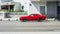 Dodge Challenger GT 2017 model year in red color moving fast on the street of Moscow. Sunny summer day in city