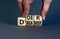 Doer or dreamer symbol. Concept words Doer or dreamer on wooden cubes. Businessman hand. Beautiful grey table grey background.