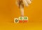 Doer or dreamer symbol. Concept words Doer or dreamer on wooden cubes. Businessman hand. Beautiful orange table orange background