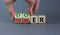 Doer or thinker symbol. Concept words Doer or thinker on wooden cubes. Businessman hand. Beautiful grey table grey background.