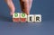 Doer or thinker symbol. Concept words Doer or thinker on wooden cubes. Businessman hand. Beautiful grey table grey background.