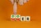 Doer or thinker symbol. Concept words Doer or thinker on wooden cubes. Businessman hand. Beautiful orange table orange background
