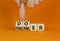 Doer or thinker symbol. Concept words Doer or thinker on wooden cubes. Businessman hand. Beautiful orange table orange background