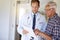 This doesnt look too bad. a male doctor talking to a senior patient in the retirement home.