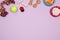 Dog accessories, food and toy on purple background. Flat lay. To