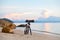 Dog assistant photographer on the paradise beach in thailand