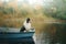 Dog in a boat in autumn. Tricolor australian shepherd in nature