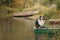 Dog in a boat in autumn. Tricolor australian shepherd in nature