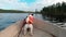 Dog in the boat. Jack russell terrier in a life jacket on the lake