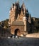 The dog at the castle. Travelling with a pet. Australian shepherd on the background of architecture