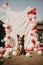 A dog with an empty white banner sign outside. A frame of multicolored balloons around. Copy space