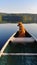 Dog enjoying life during a canoe ride on the calm lake