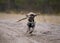 Dog fetching a wooden stick.