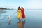 Dog-Friendly Beach. Women In Boho Dress With Dog On Coast. Silhouette Reflection And Footprints On Wet Sand