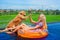 Dog give high five to happy girl swimming in pool