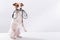 The dog holds a leash in his mouth on a white background. Jack russell terrier calls the owner for a walk.