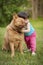 Dog hugged by toddler