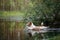 The dog jumps into the water. active jack russell terrier on the lake, nature