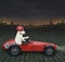 Dog labrador drives retro red sports car 2