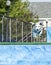 Dog leaping in midair over pool