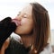 Dog licking face of young attractive woman