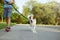 Dog and little child walking at the park. Obedience and friendship concept