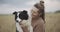 Dog lover stylish girl wearing sunglasses hugging her doggy during they walk. Portrait of smiling young woman kissing