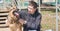 A dog and a man, a German shepherd and a young man walk on a sunny day