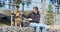 A dog and a man, a German shepherd and a young man walk on a sunny day