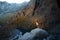 dog in the mountains lake . Nova Scotia Duck Tolling Retriever on peak of rocks at sunset. . Hiking with a pet