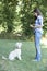 Dog Owner Teaching Pet Lurcher To Sit