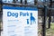 Dog park sign with rules policies on galvanized vinyl-coated chain link fences, steel posts and panels at rest area public picnic