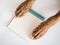 Dog paws hold a notepad. Close-up, indoors